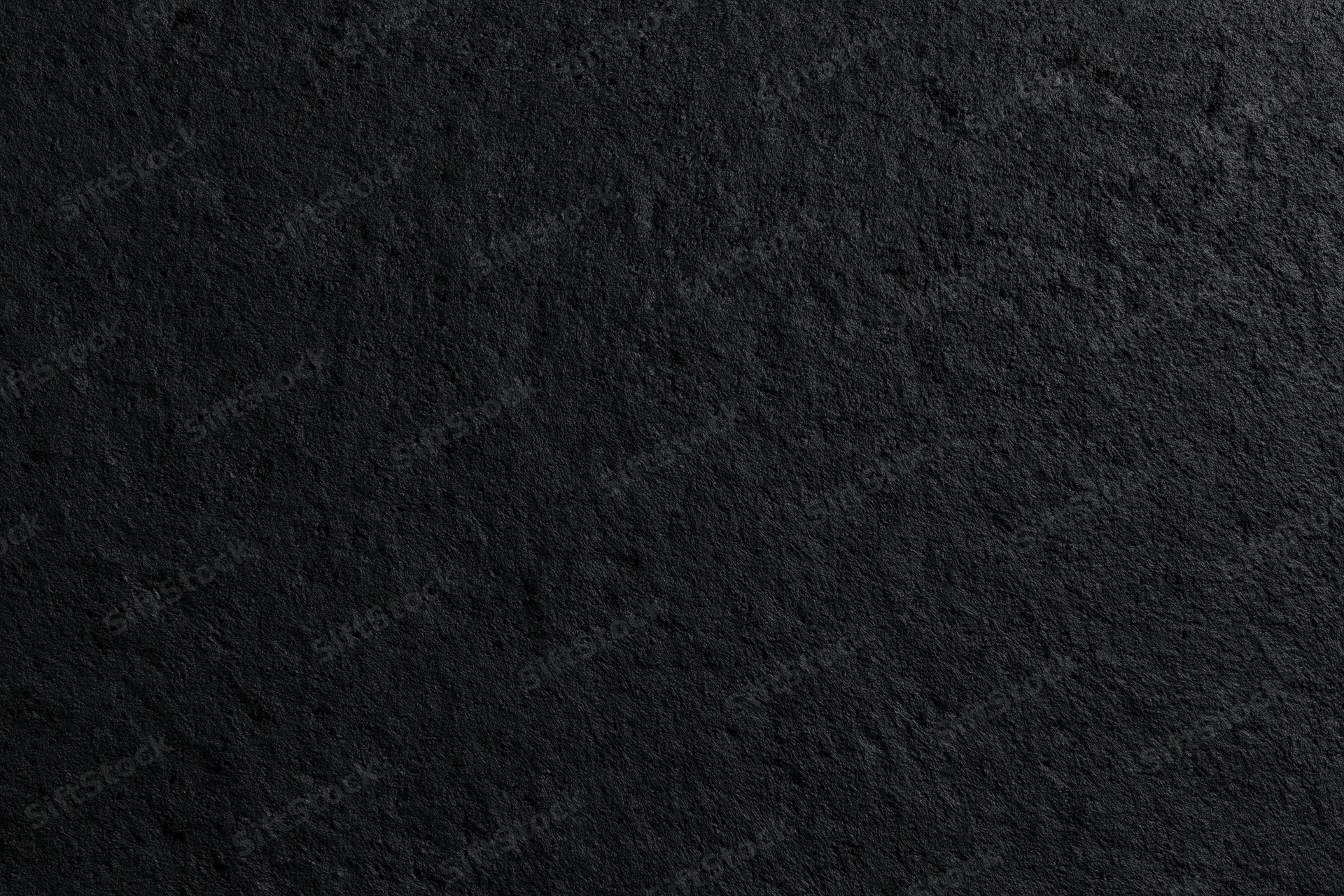 Close-up of rough dark concrete wall surface