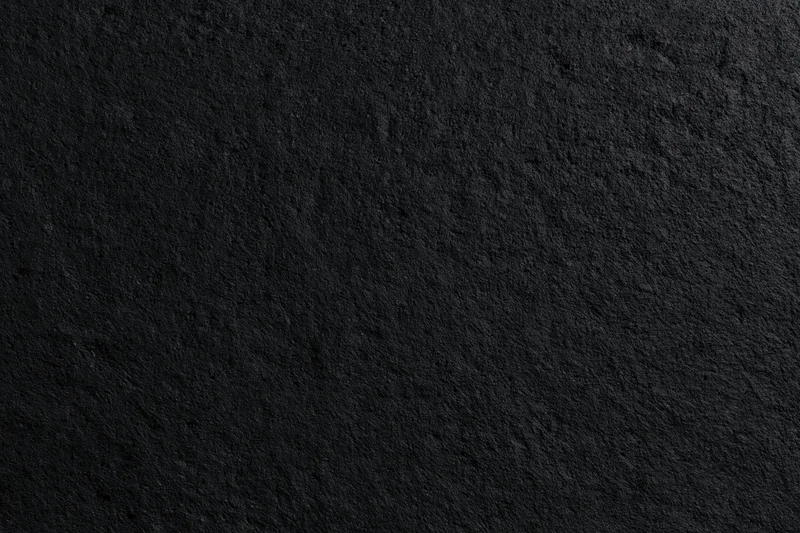 Close-up of rough dark concrete wall surface