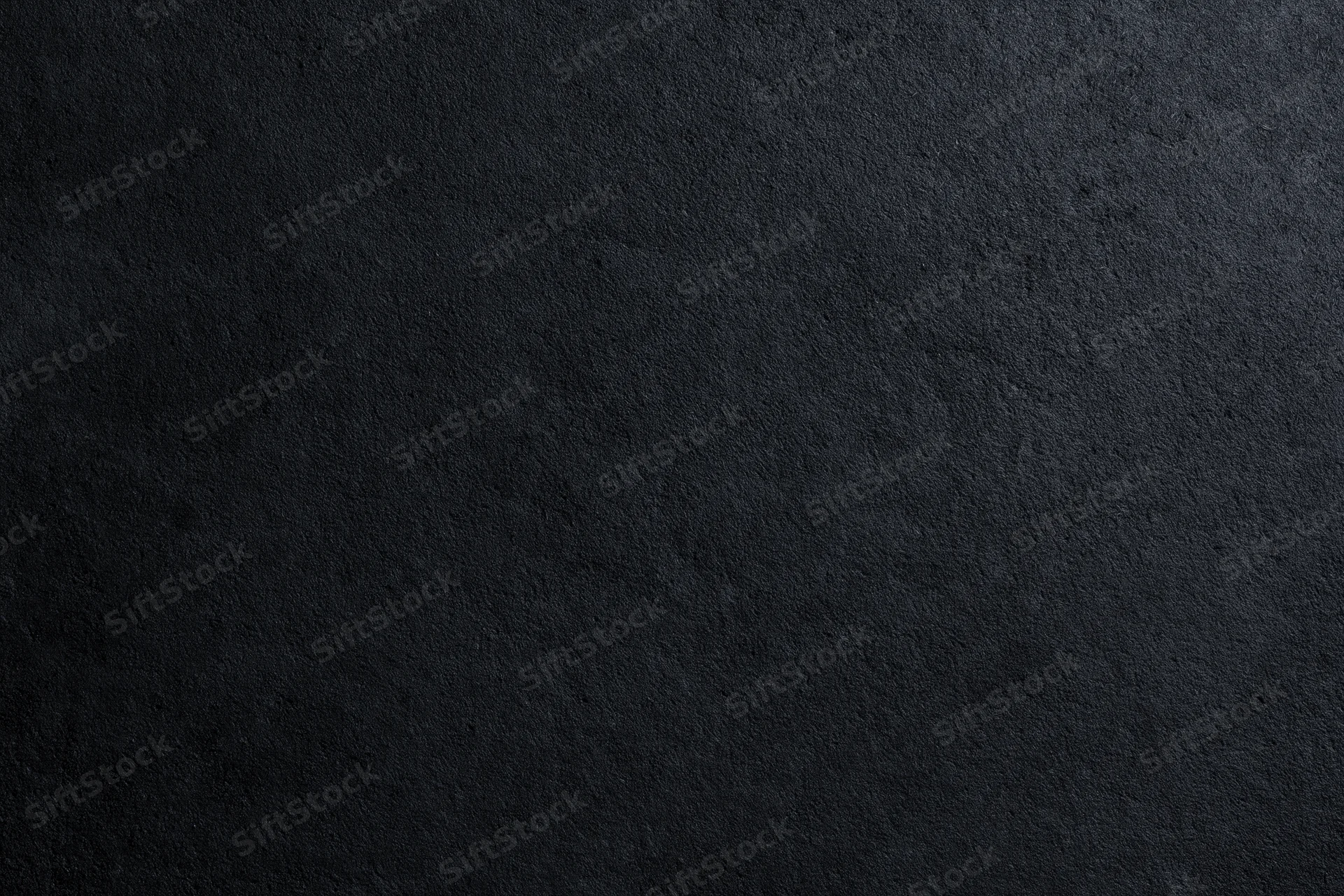 Close-up of rough dark concrete wall surface filling the frame