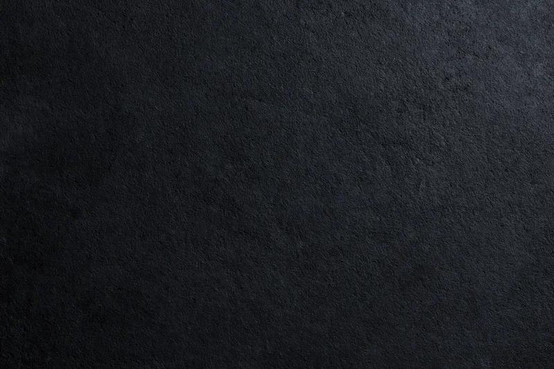 Close-up of rough dark concrete wall surface filling the frame