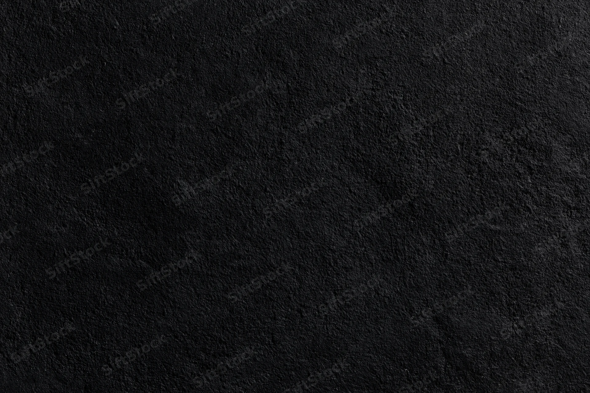 Close-up of rough dark concrete wall surface
