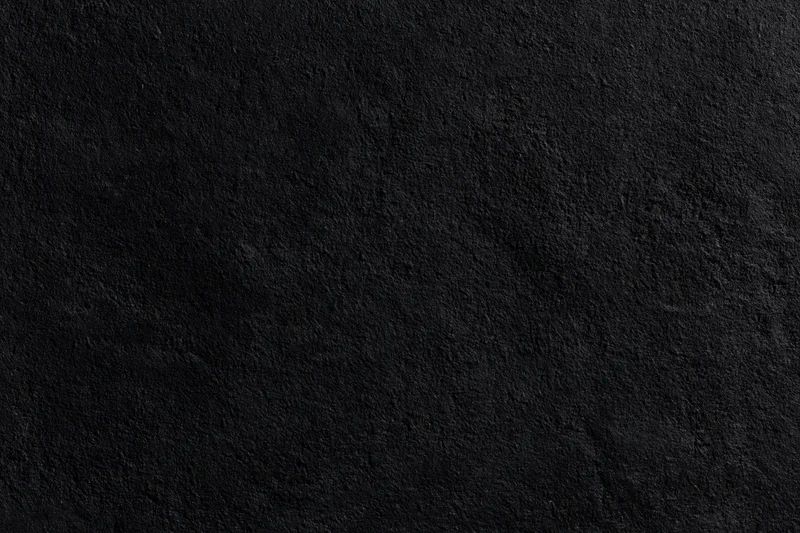 Close-up of rough dark concrete wall surface