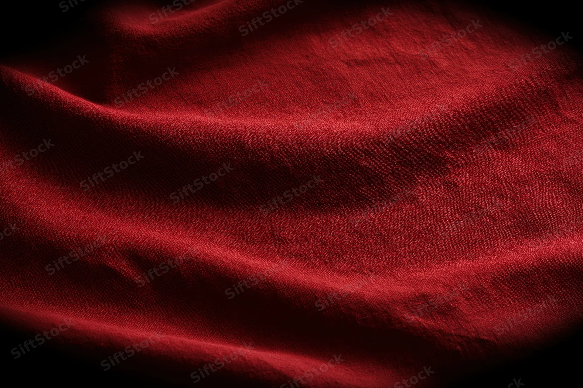 Closeup of draped red fabric with folds and shadows