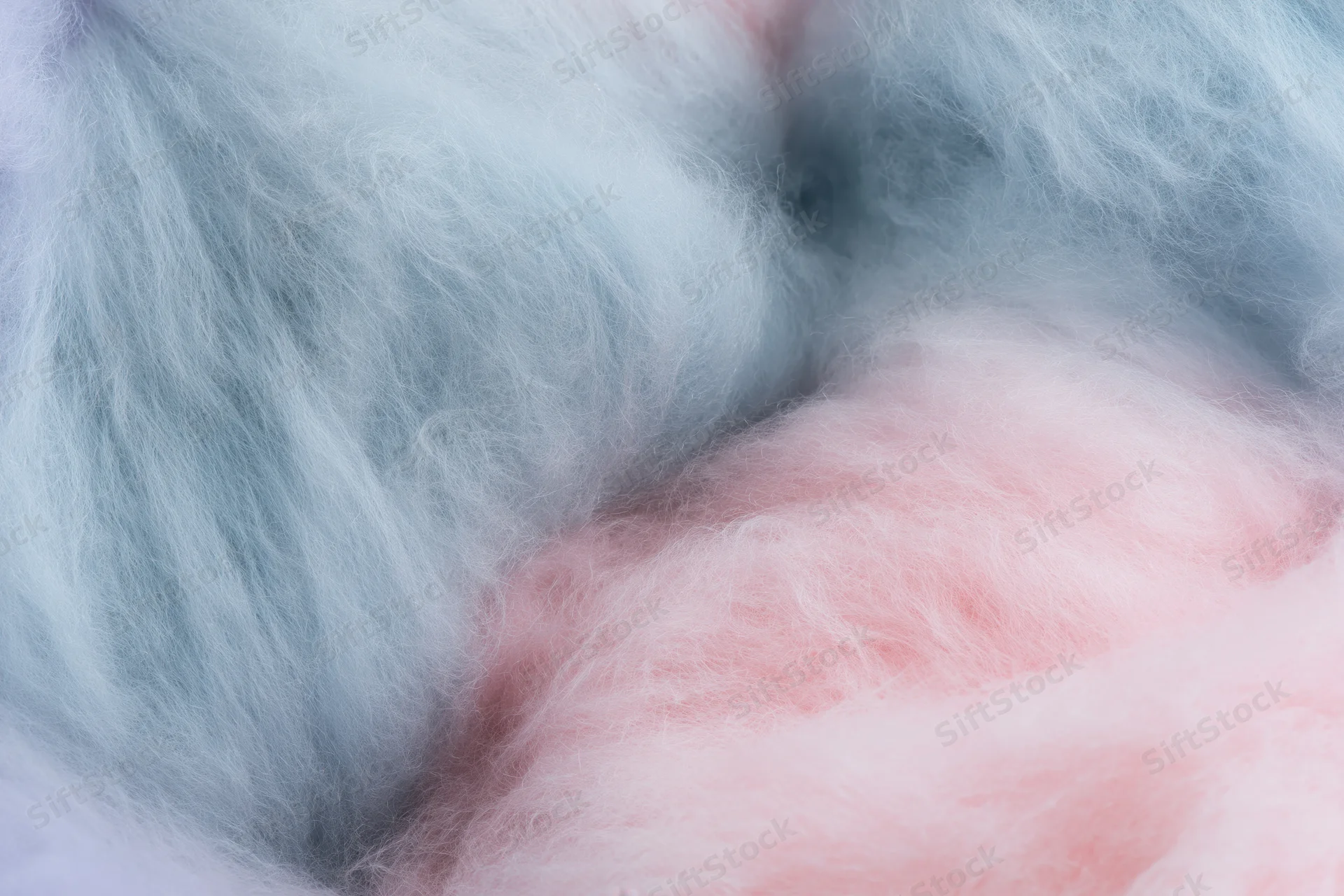 Close-up of fluffy pink and blue cotton candy filling the frame
