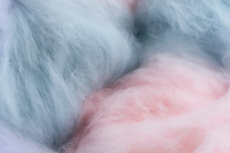 Close-up of fluffy pink and blue cotton candy filling the frame