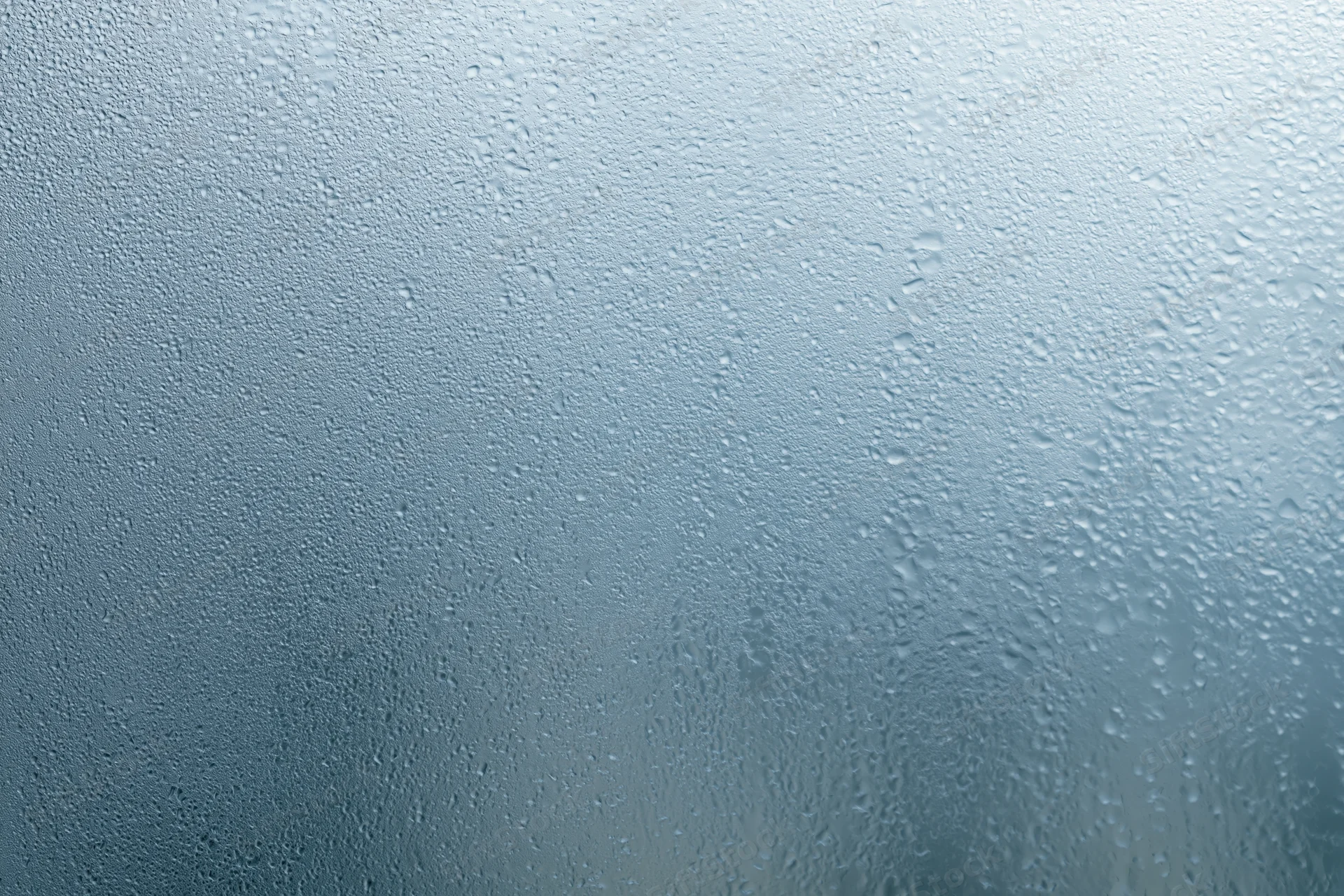 Close-up of water droplets on a fogged glass window surface