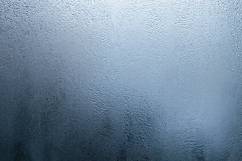 Close-up of water condensation on a fogged glass surface