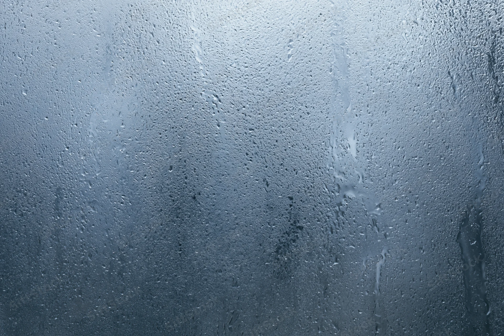 Close-up of water condensation on a fogged glass window surface