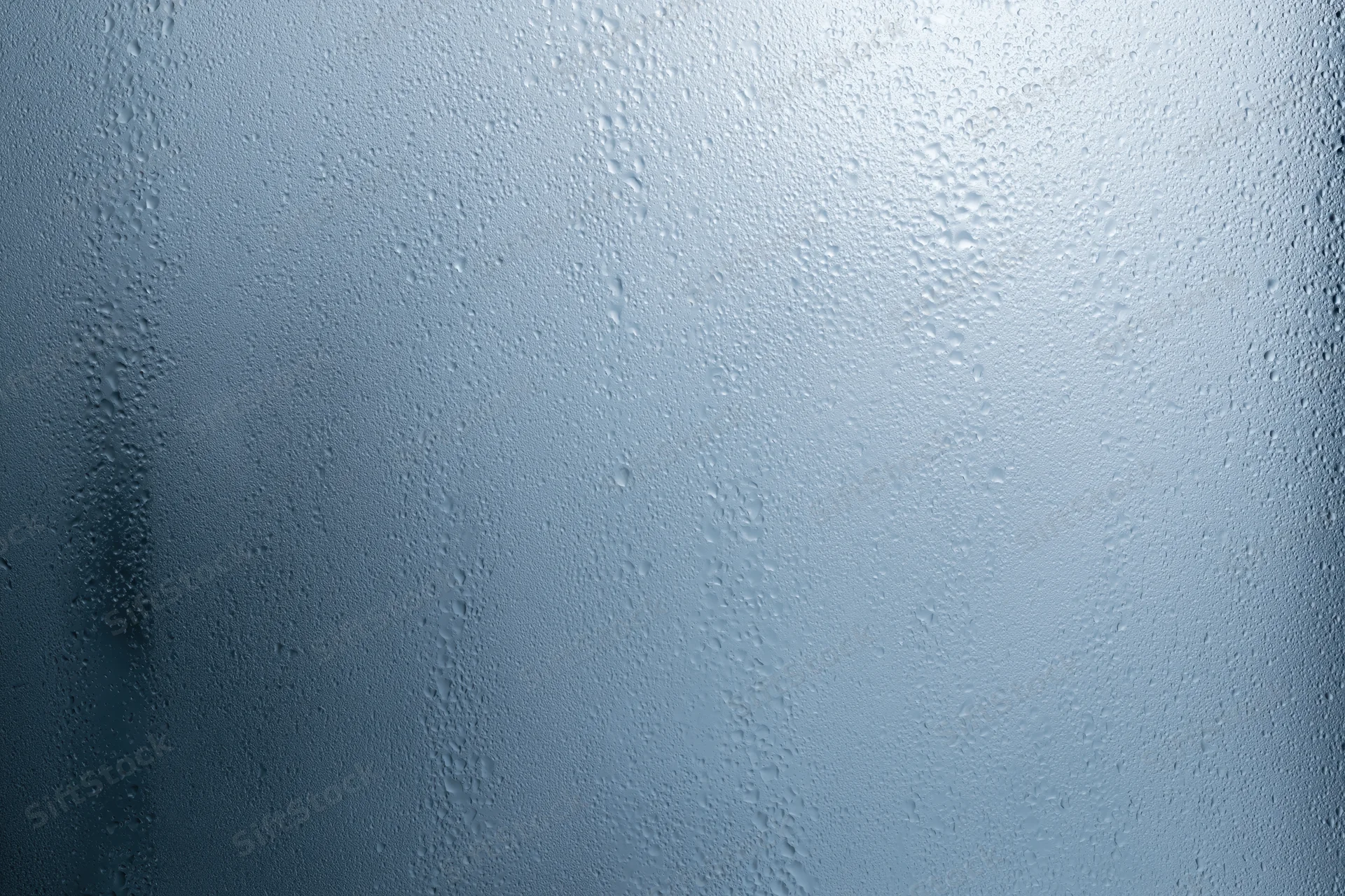 Close-up of water droplets on a fogged glass window surface