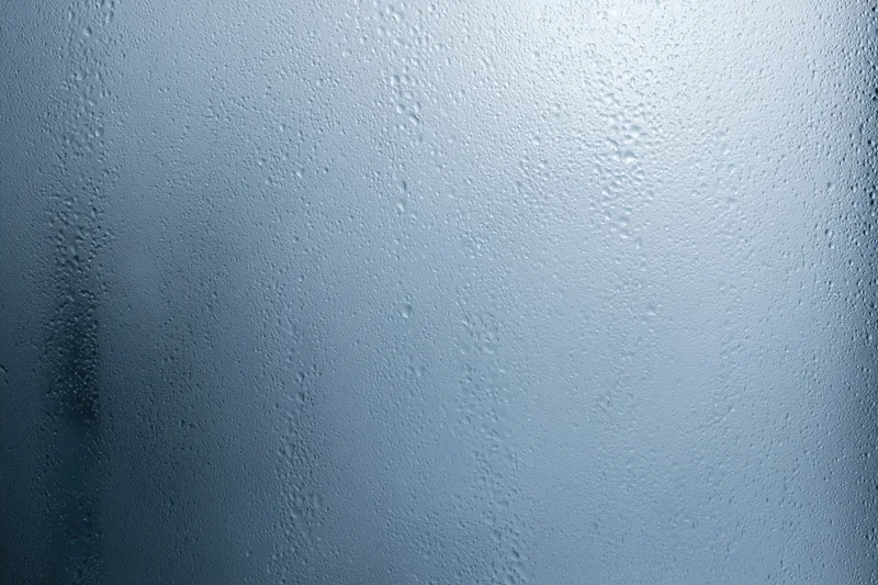 Close-up of water droplets on a fogged glass window surface