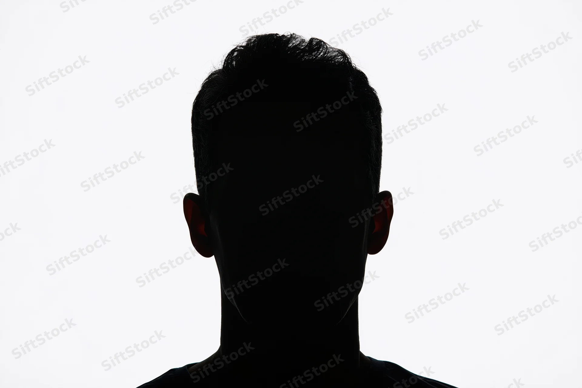 Silhouette of a man's head and shoulders facing forward against white background