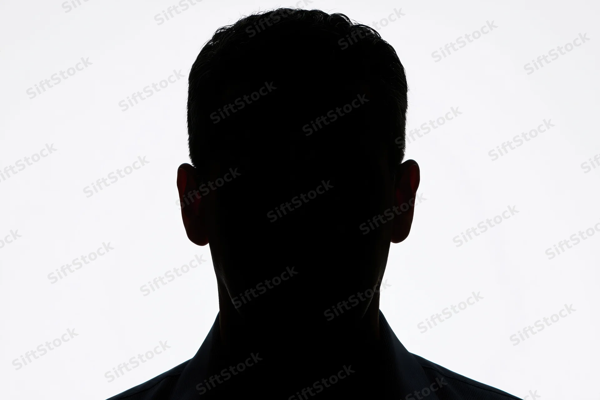 Silhouette of a man's head and shoulders facing forward against white background