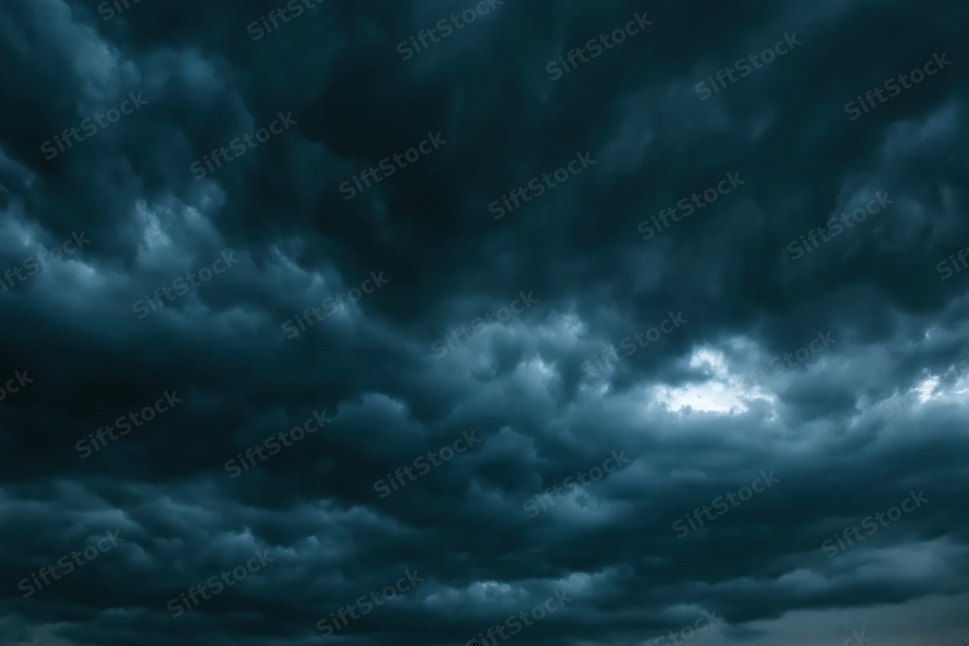Dark stormy sky filled with heavy roiling clouds showing dramatic weather patterns