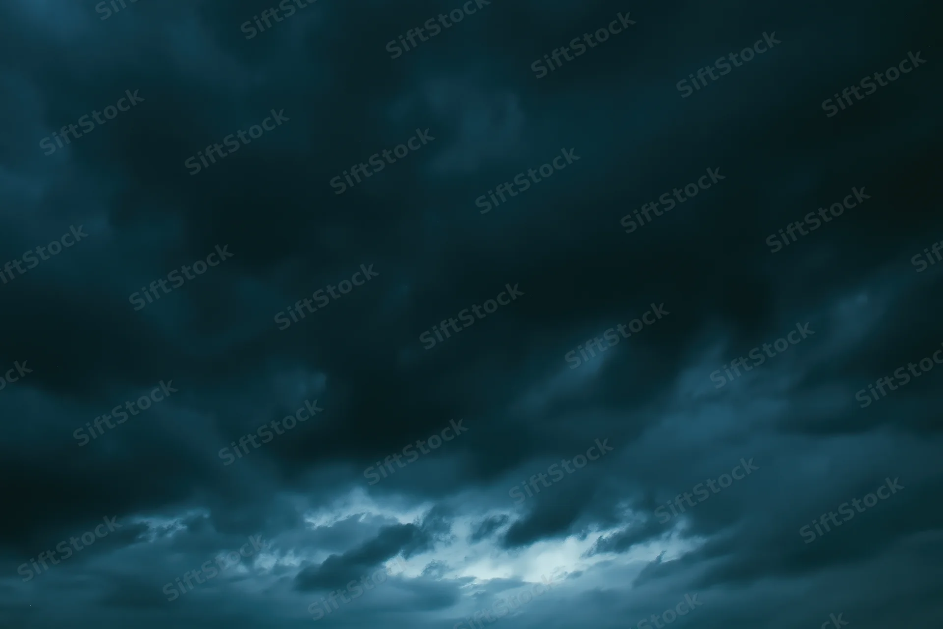 Dark stormy sky filled with heavy roiling clouds at twilight