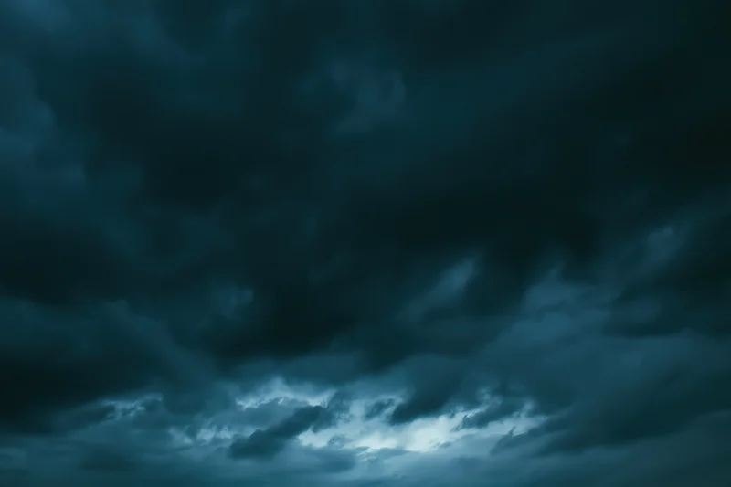 Dark stormy sky filled with heavy roiling clouds at twilight