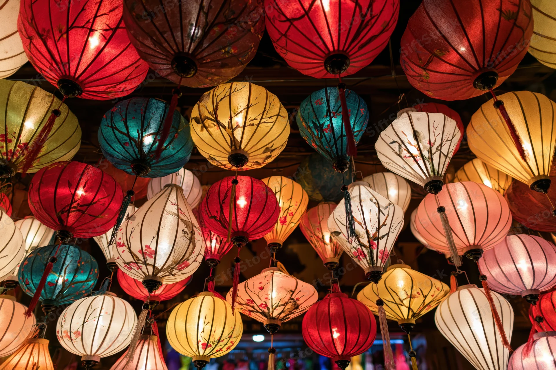 Glowing silk lanterns hanging densely from a market ceiling at night