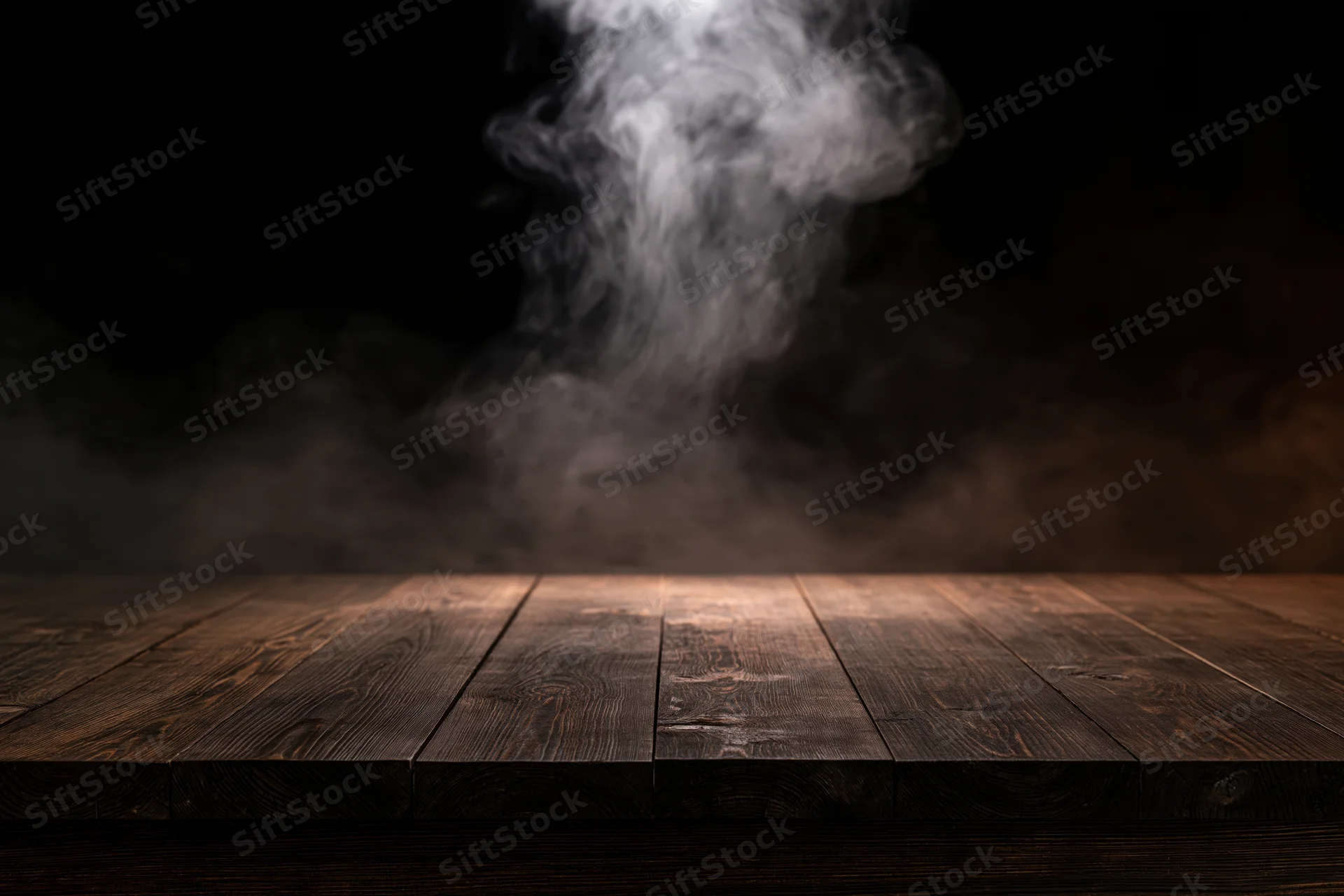 Dark wooden table surface with rising smoke against black background