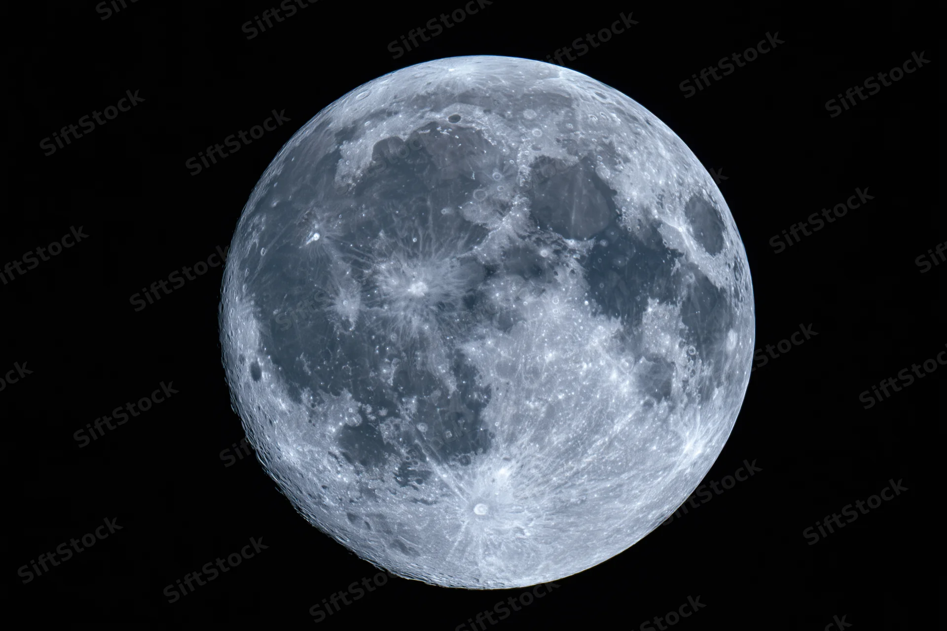 Full moon centered against pure black night sky in close-up view