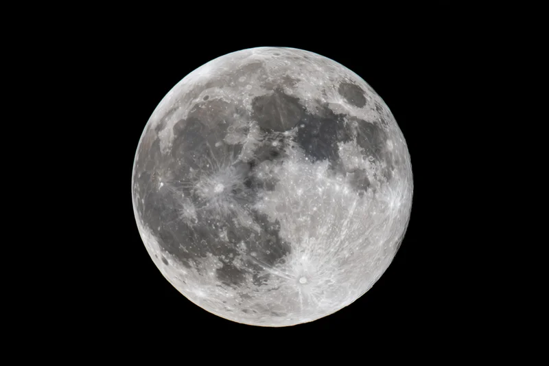 Full moon centered against a pure black night sky close-up