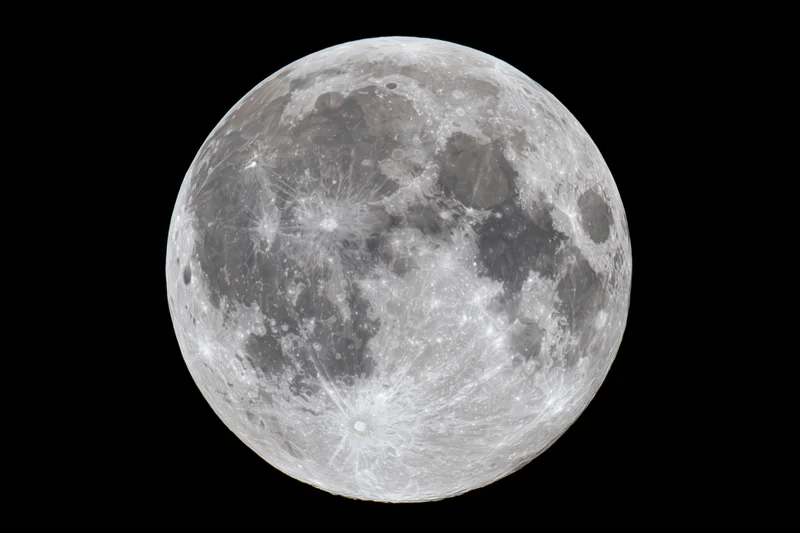 Full moon with detailed craters and surface textures against black space