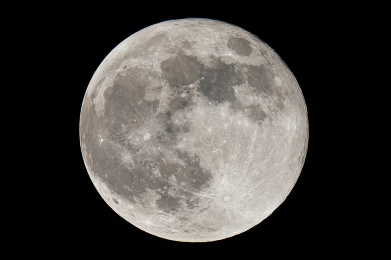 Full moon filling the frame against a black sky, detailed surface with craters and maria visible