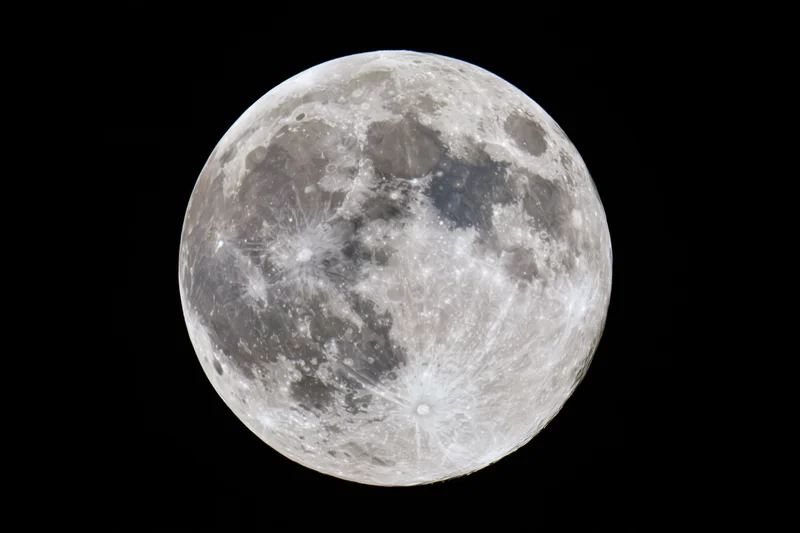 Full moon filling the frame against a black sky, showing detailed craters and maria