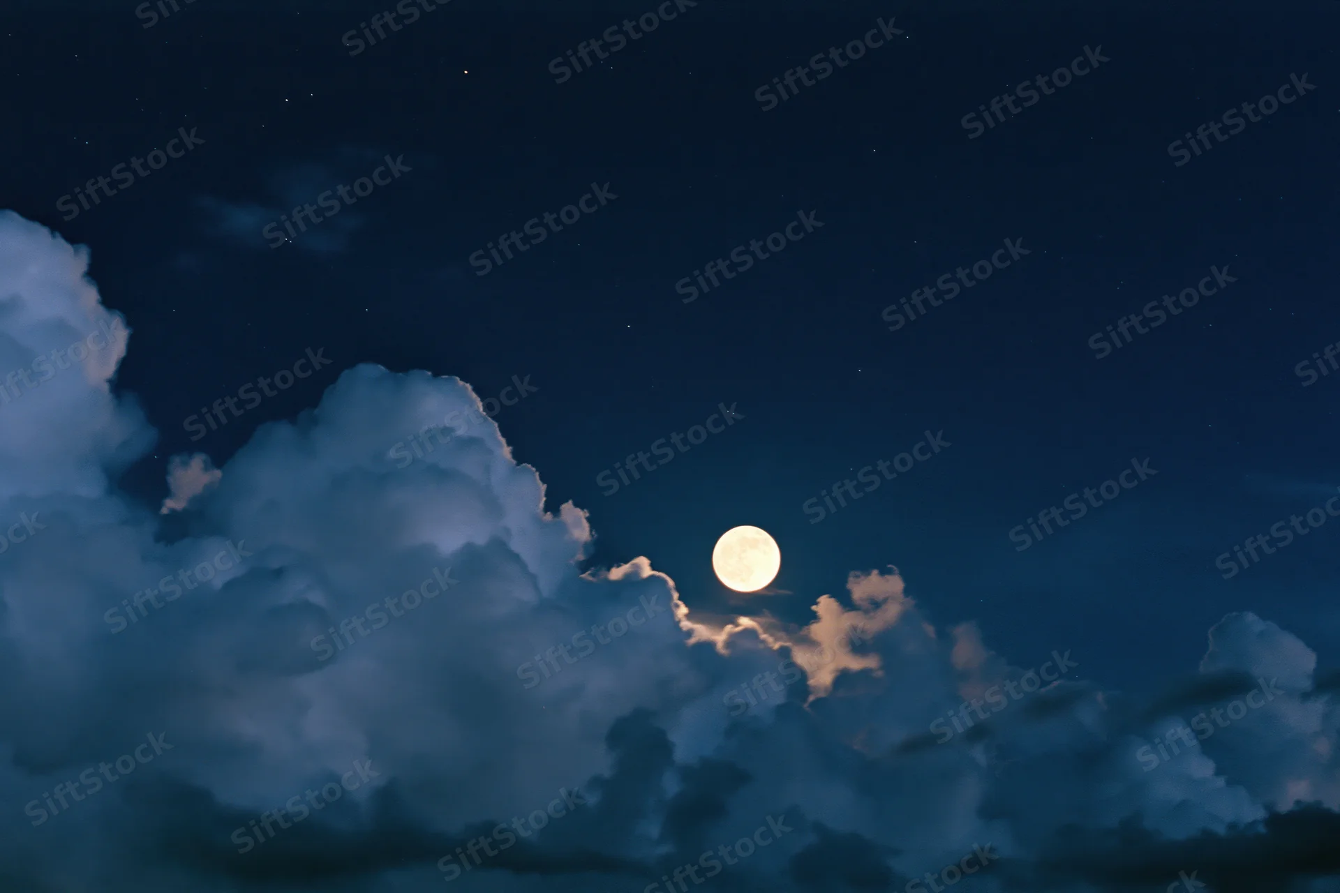 Full moon rising above dense storm clouds in night sky
