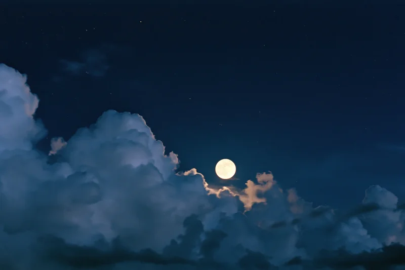 Full moon rising above dense storm clouds in night sky