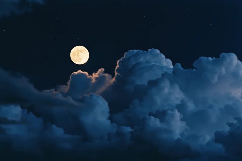Full moon rising above dense storm clouds in the night sky