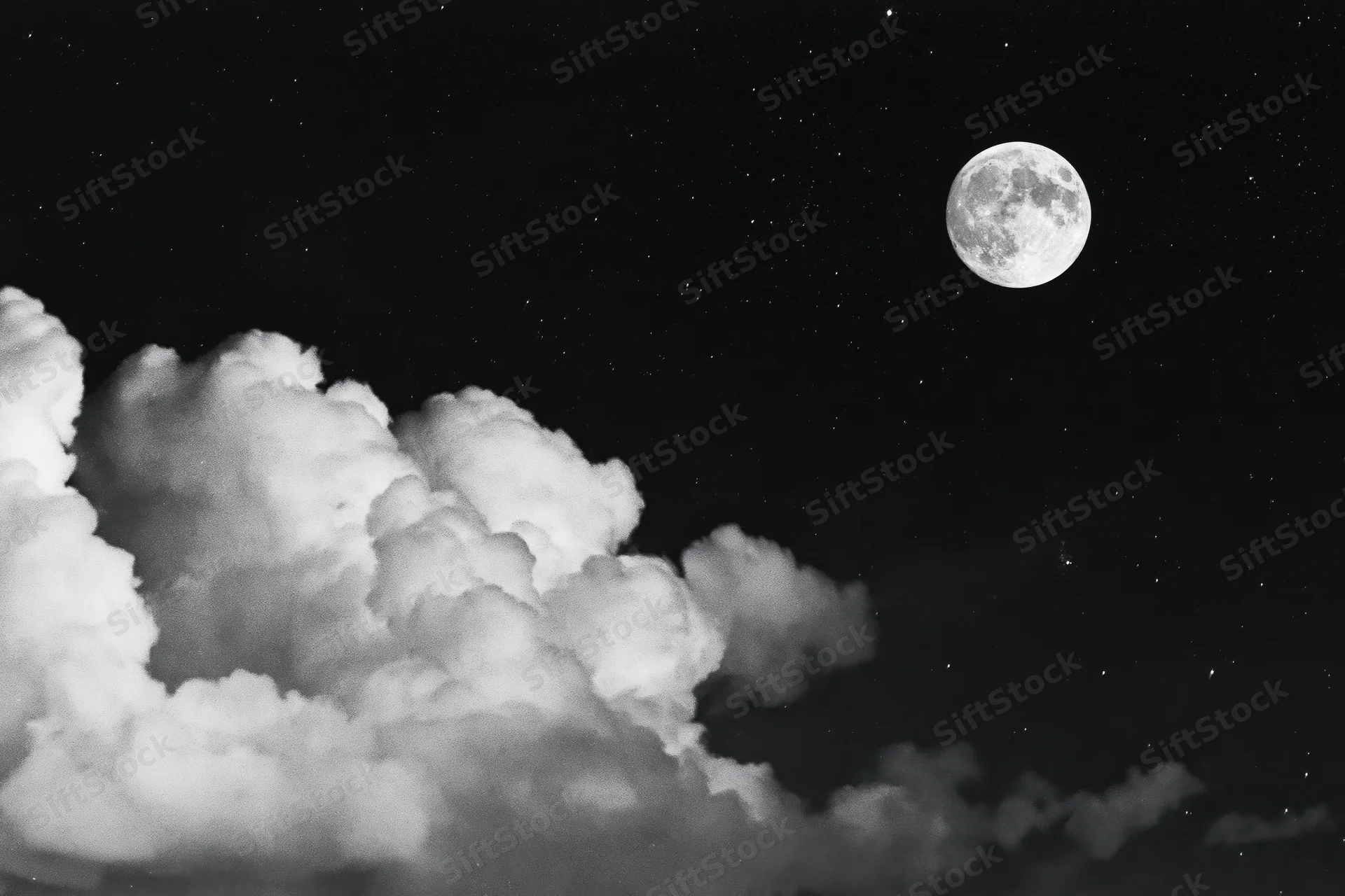 Full moon rising above billowing cumulus clouds in a starry night sky