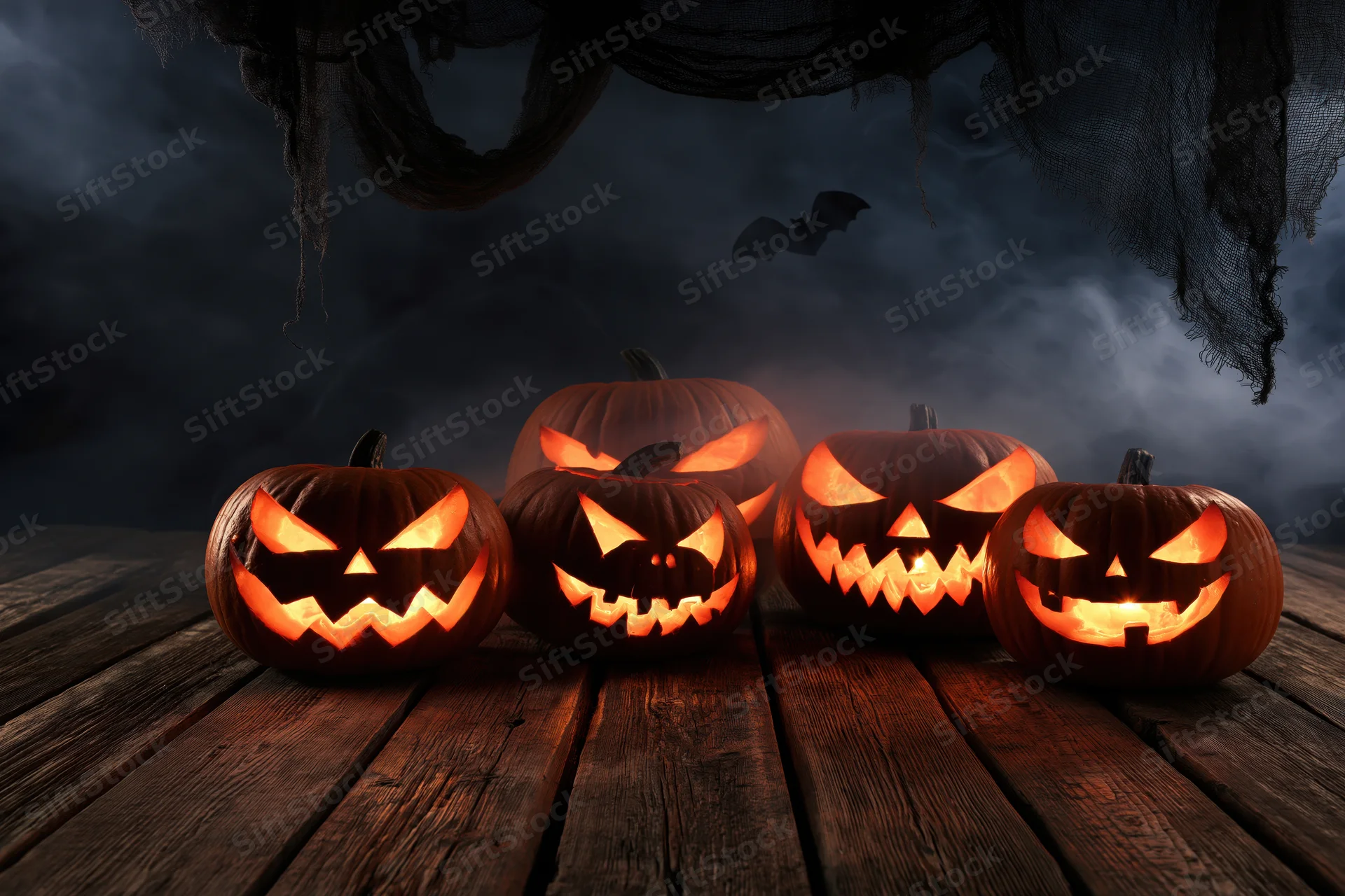Carved jack-o-lanterns glowing on a wooden table under dark cobwebs with a bat flying in the background