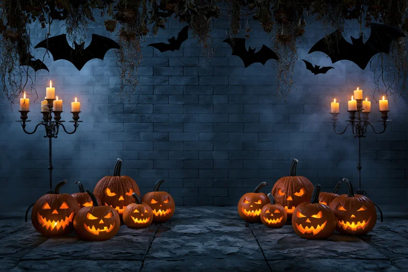 Carved jack-o-lanterns glowing orange on stone floor with candelabras and bats against dark brick wall