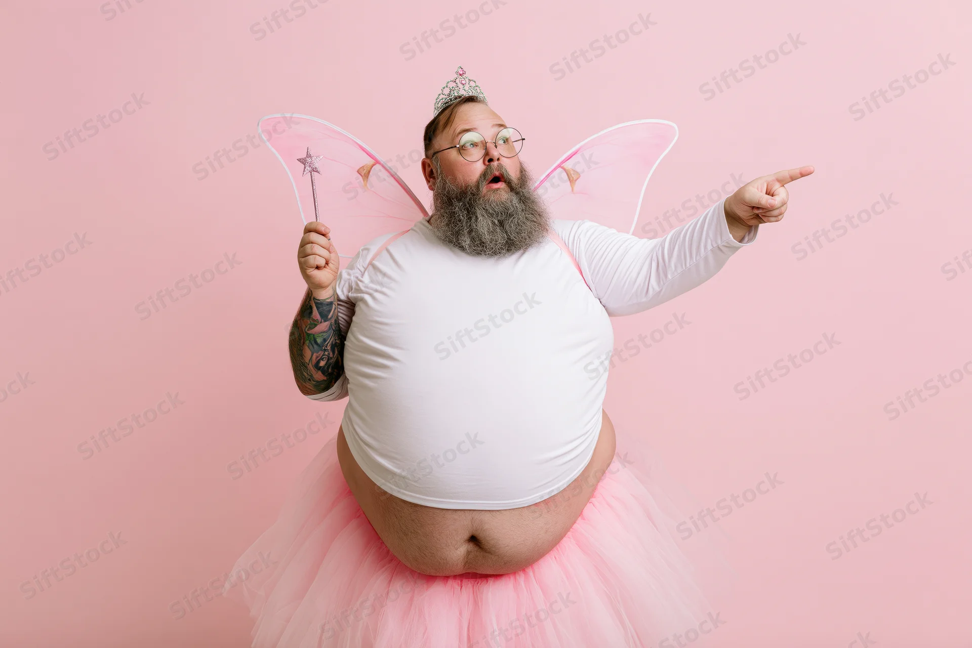 Heavyset bearded man in tooth fairy costume pointing with surprised expression against pink backdrop