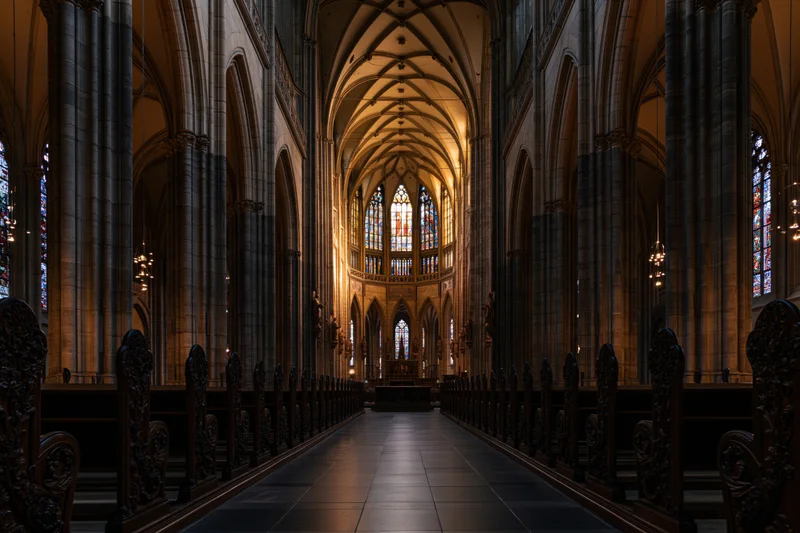 Gothic cathedral nave interior with stone columns and stained glass windows lining the central aisle