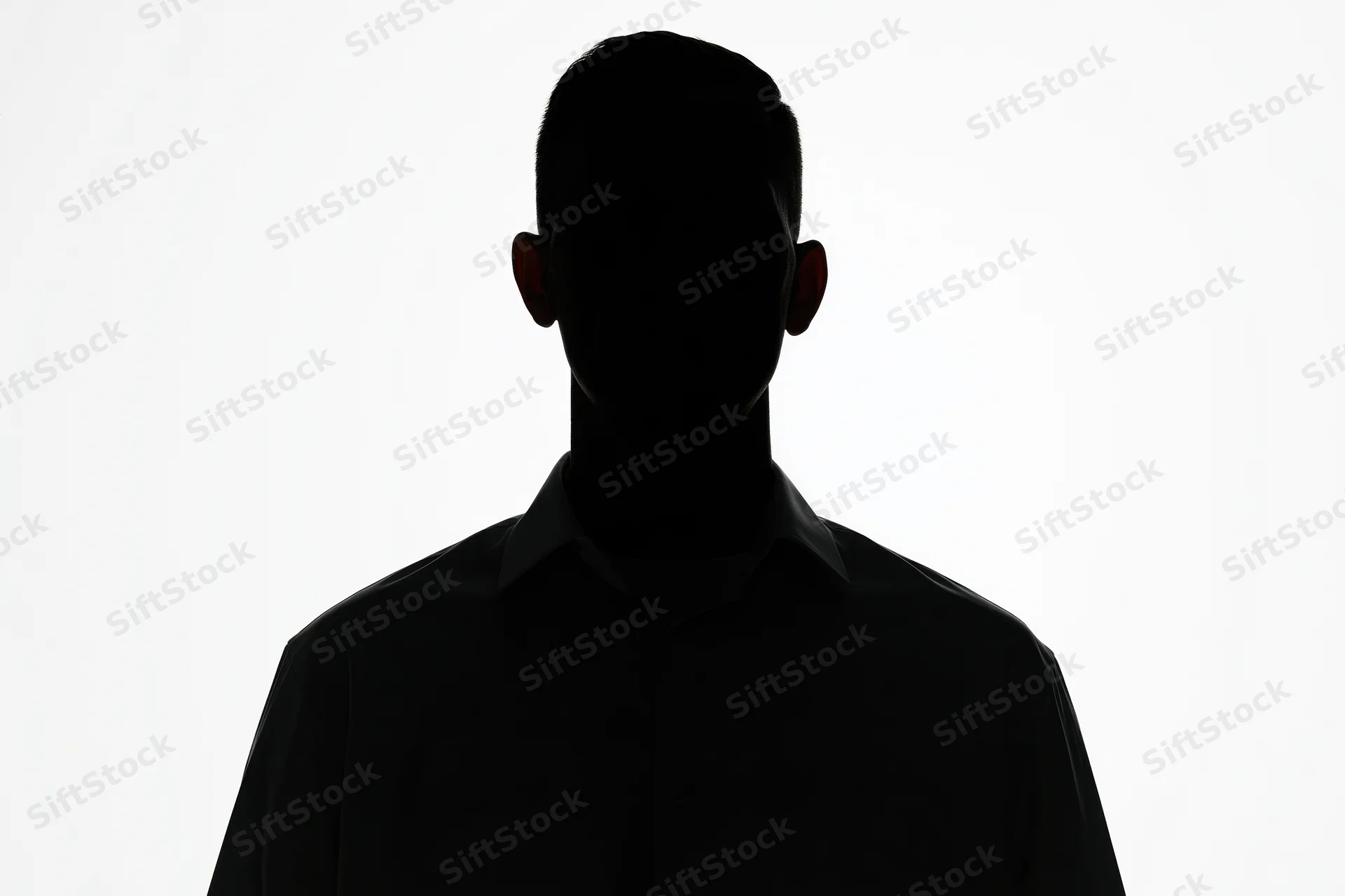 Silhouette of a man standing still facing forward against white background