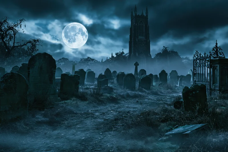 Old graveyard at night with crumbling headstones and a gothic church under a full moon