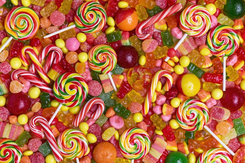 Overhead flat lay of assorted mixed candies densely packed together