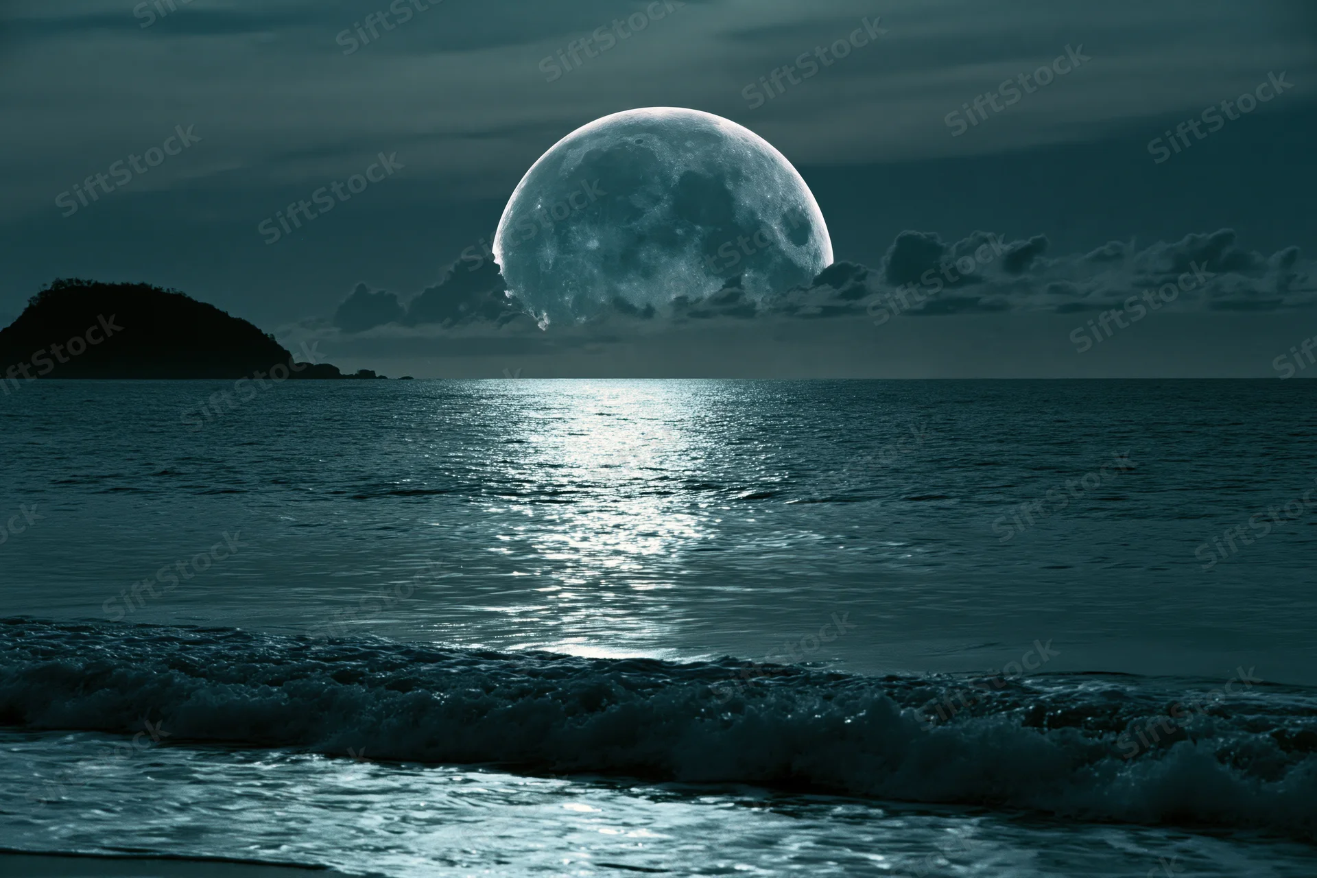 Oversized full moon rising over calm ocean at night with moonlight reflecting on water surface