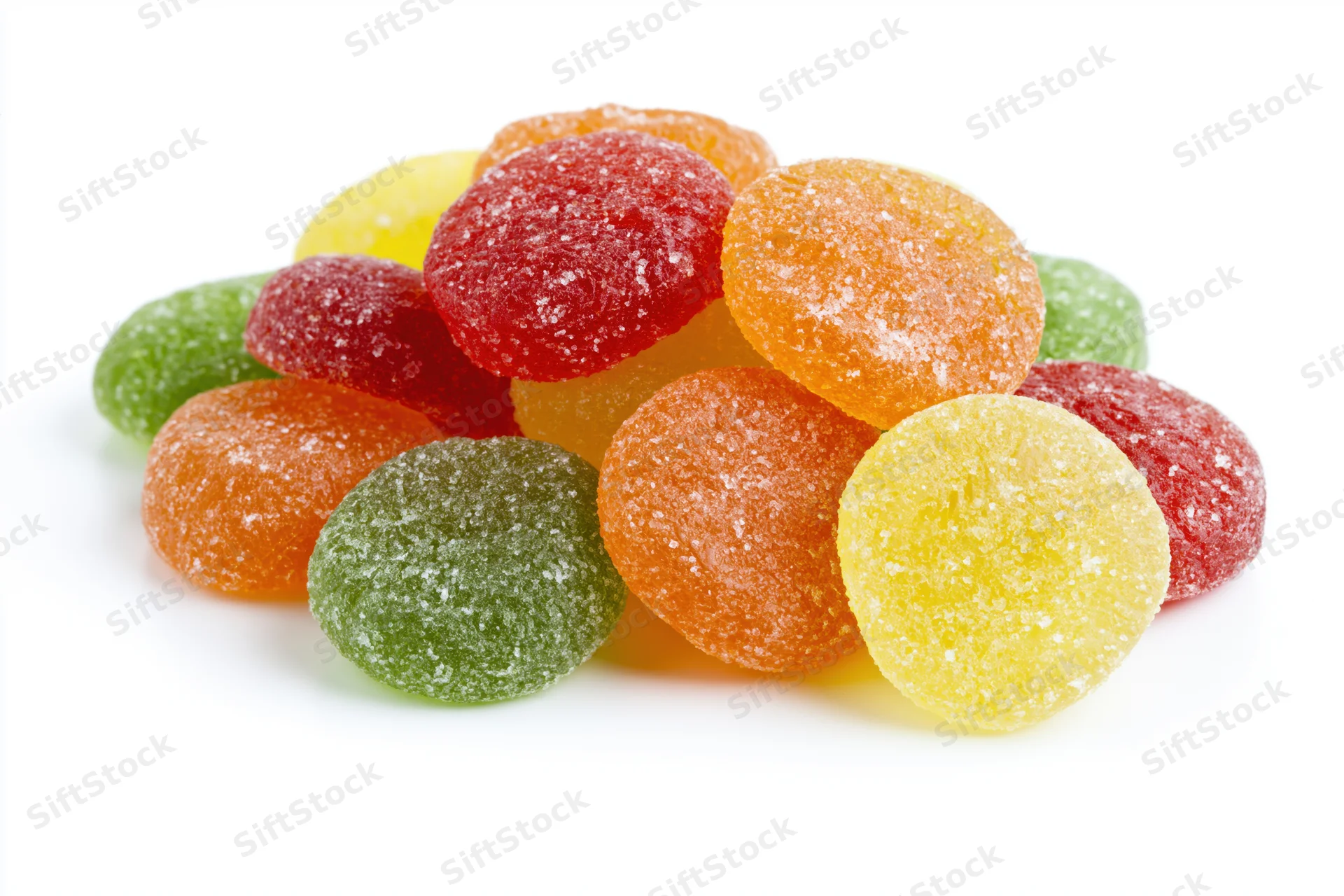 Pile of colorful sugar-coated jelly candy drops on white background
