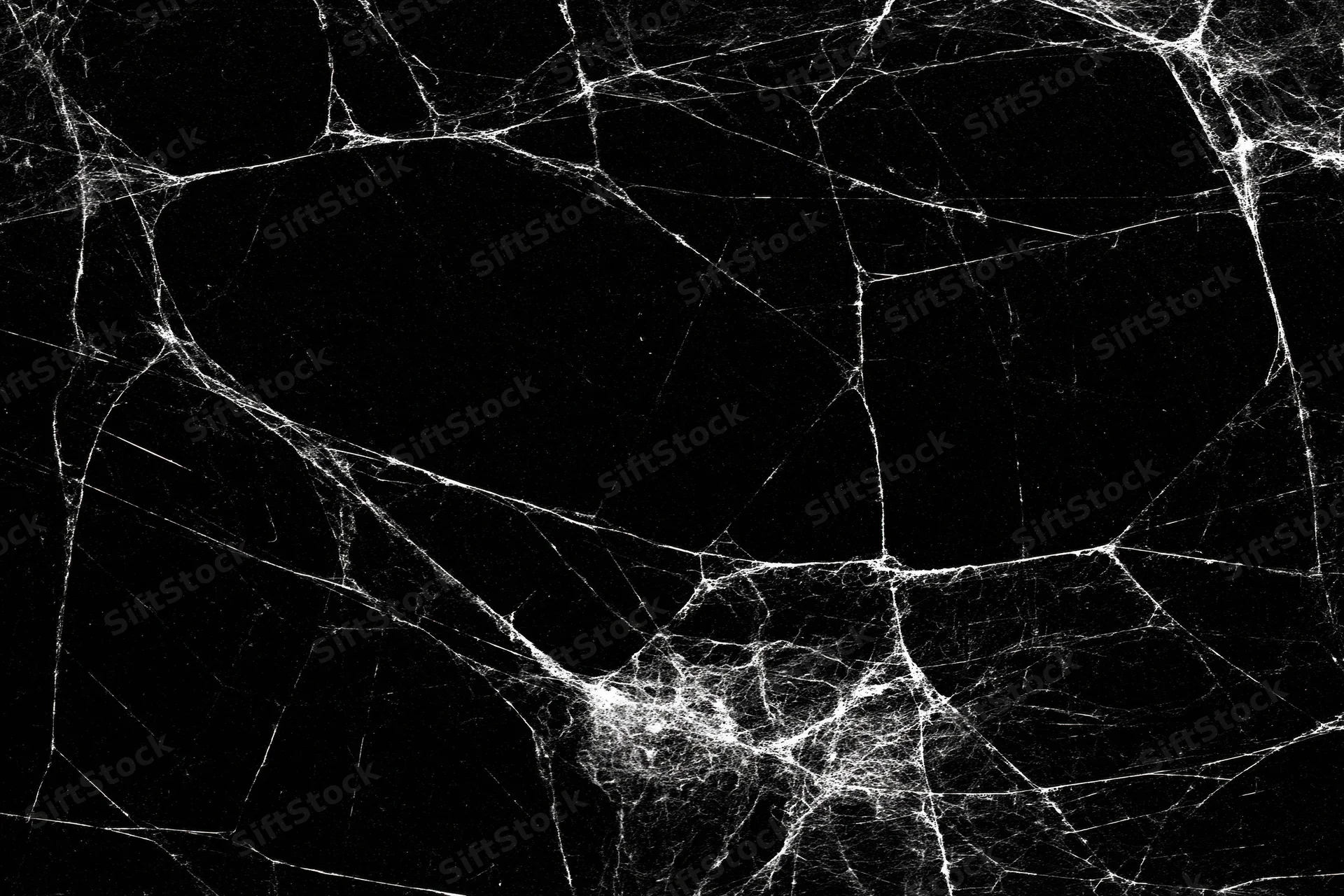 Tangled dusty spider web stretched across a dark void