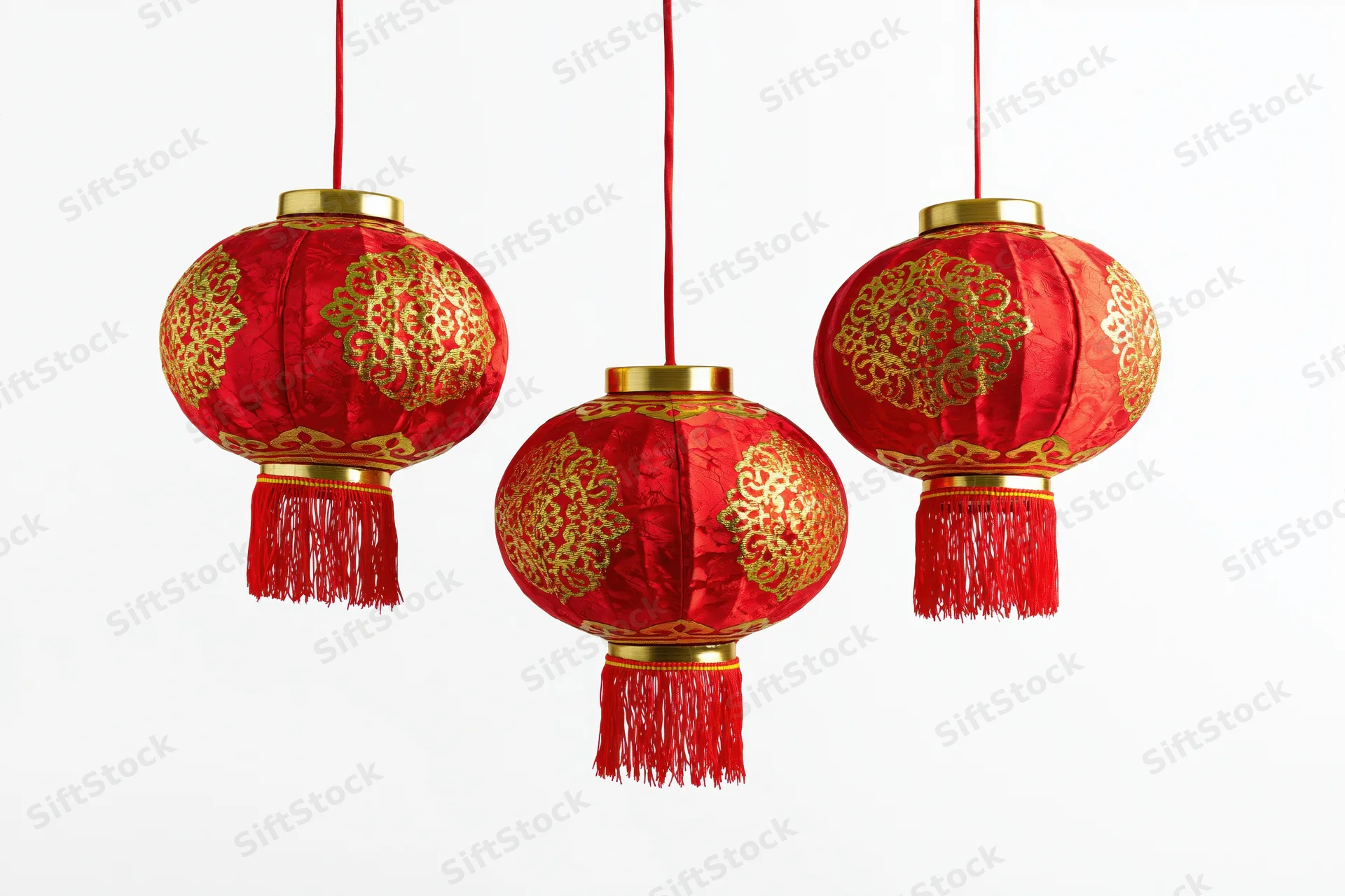 Three red and gold chinese paper lanterns hanging in a row against white background