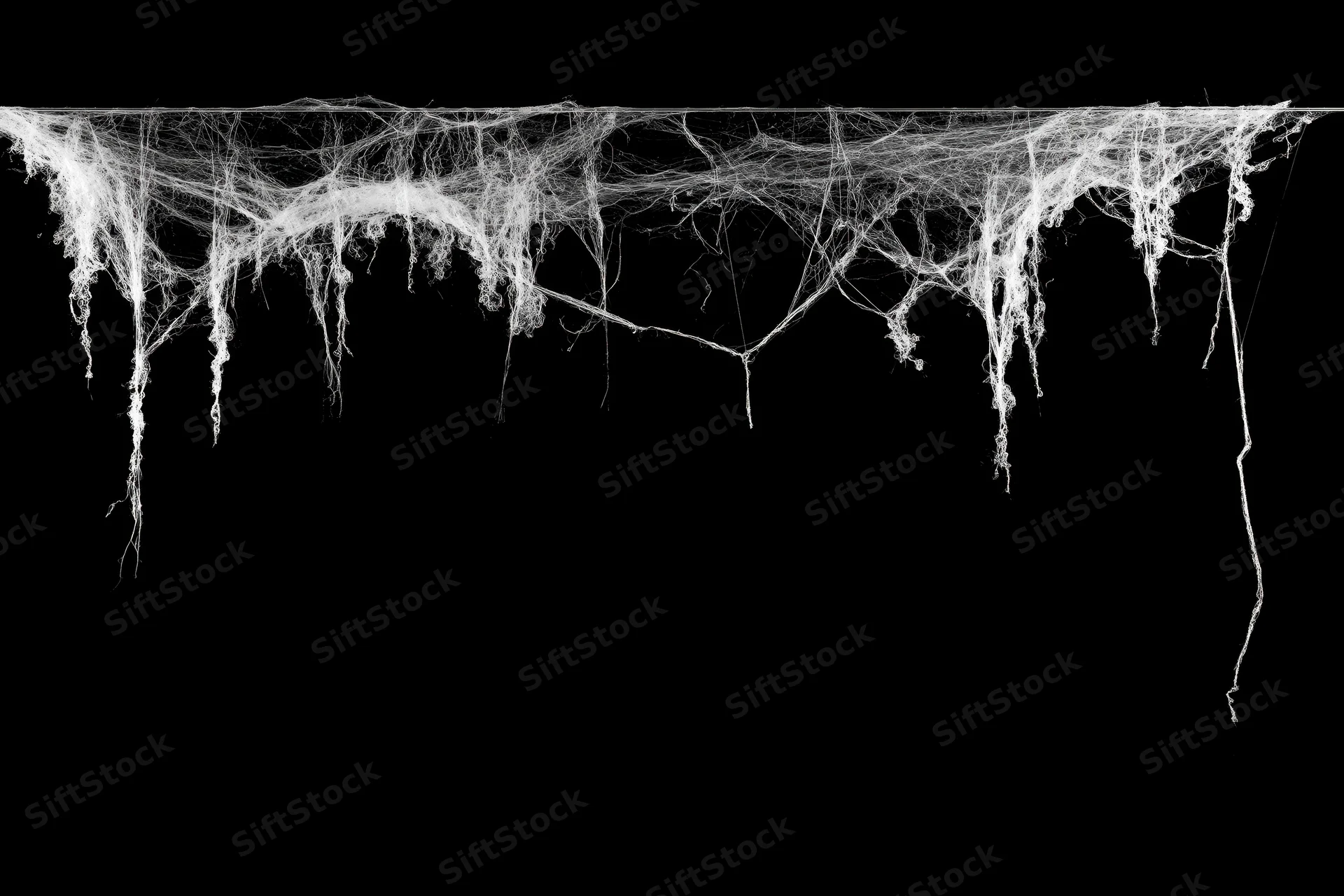 Tangled white spiderweb hanging from a horizontal line against black background