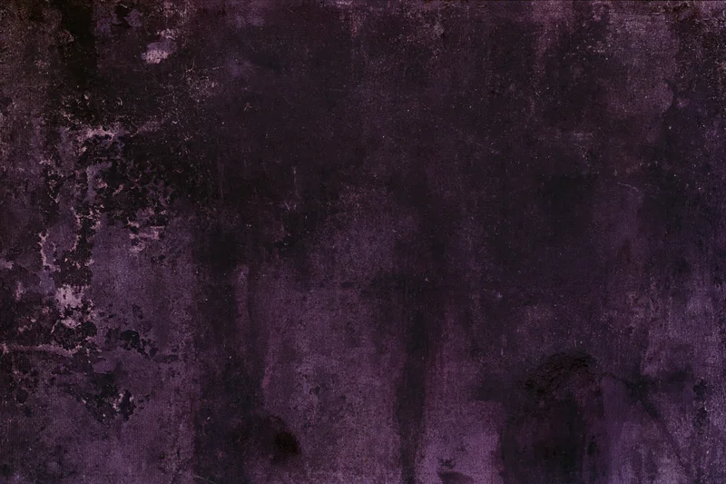 Weathered concrete wall surface filling the frame with dark purple and black tones