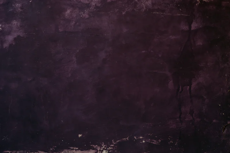 Weathered concrete wall surface filling the frame with cracks and discoloration