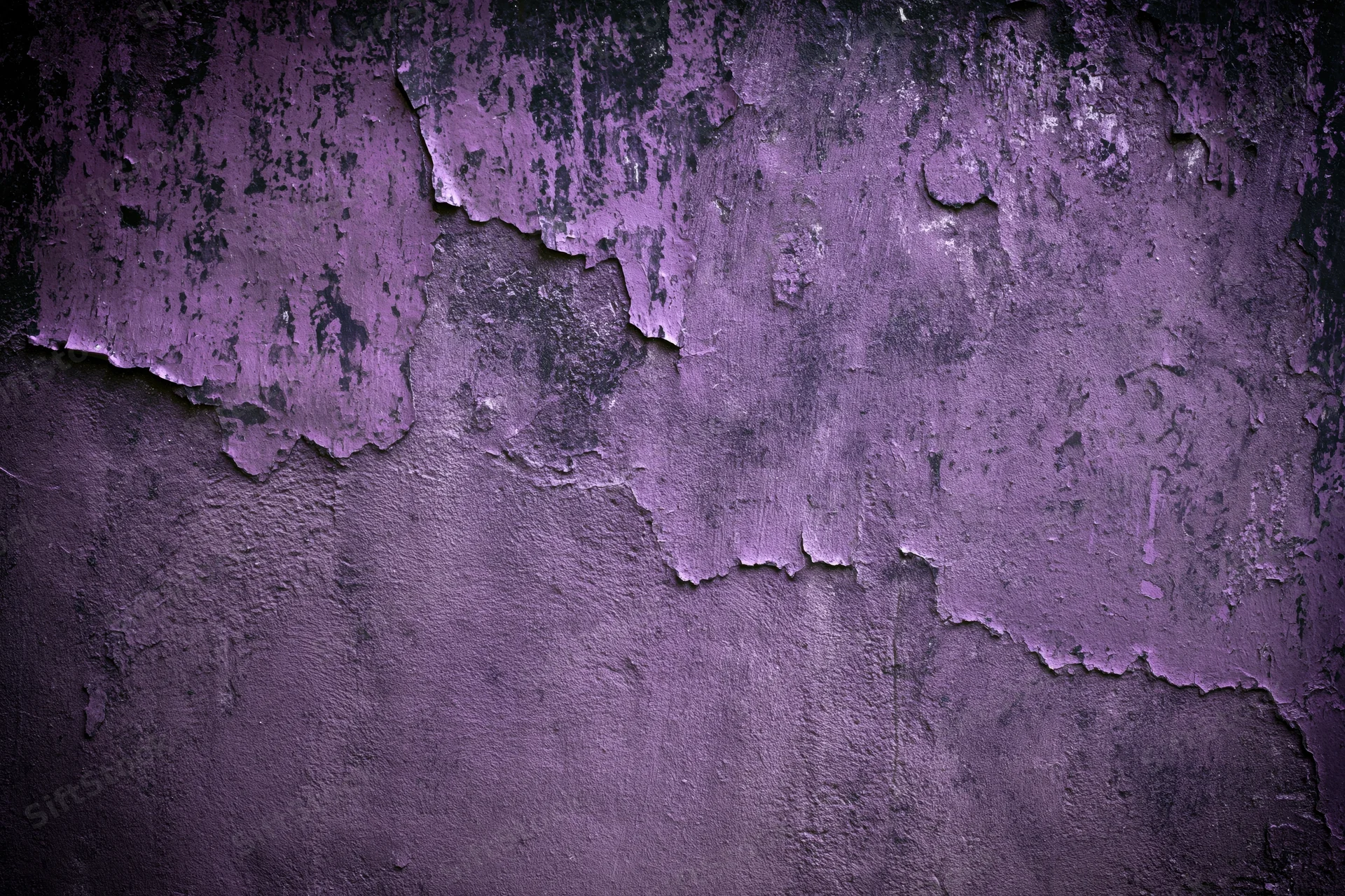 Weathered concrete wall with peeling purple paint showing cracked and flaking texture