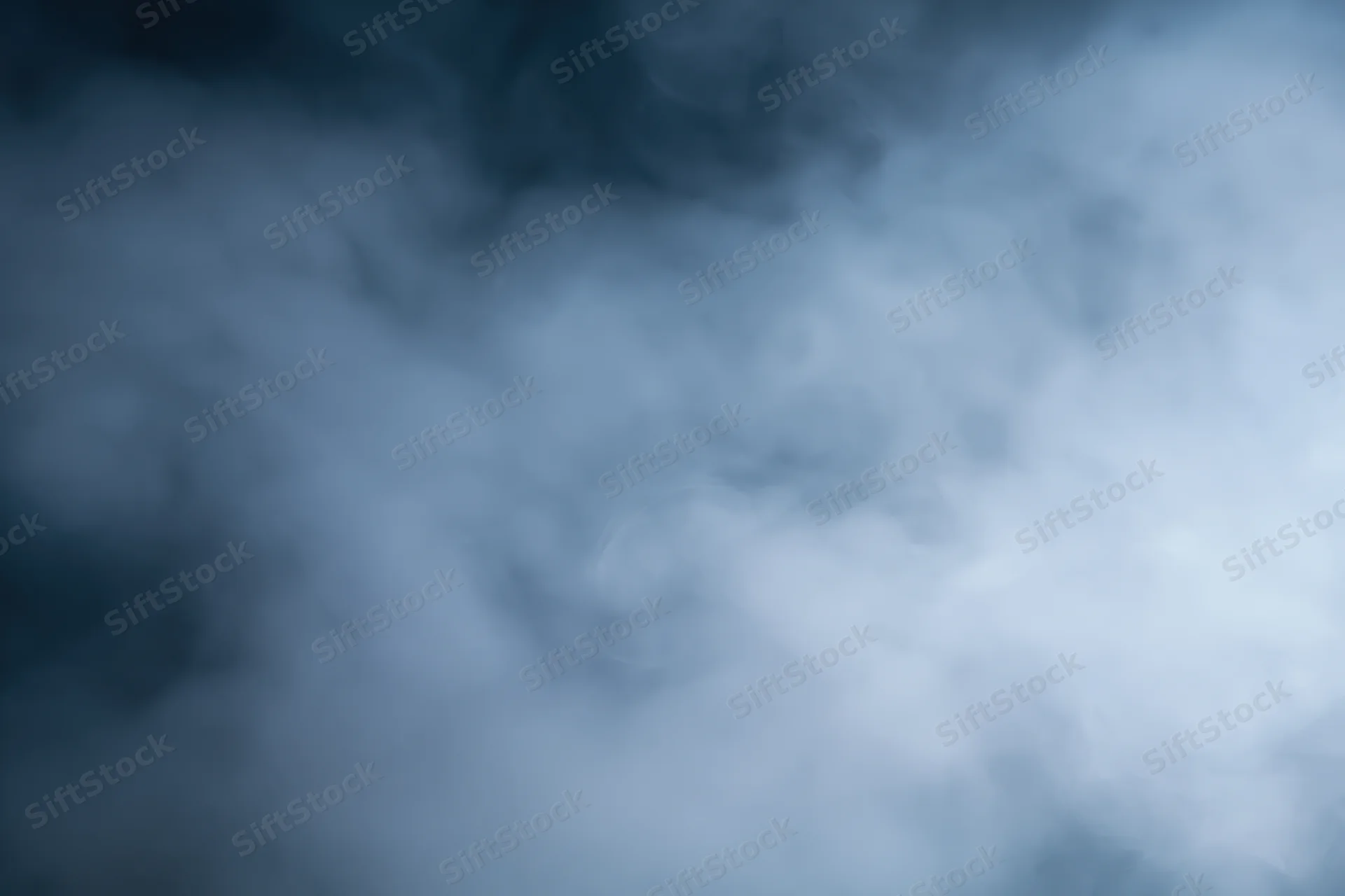Wisps of white smoke drifting and swirling in a dark atmosphere