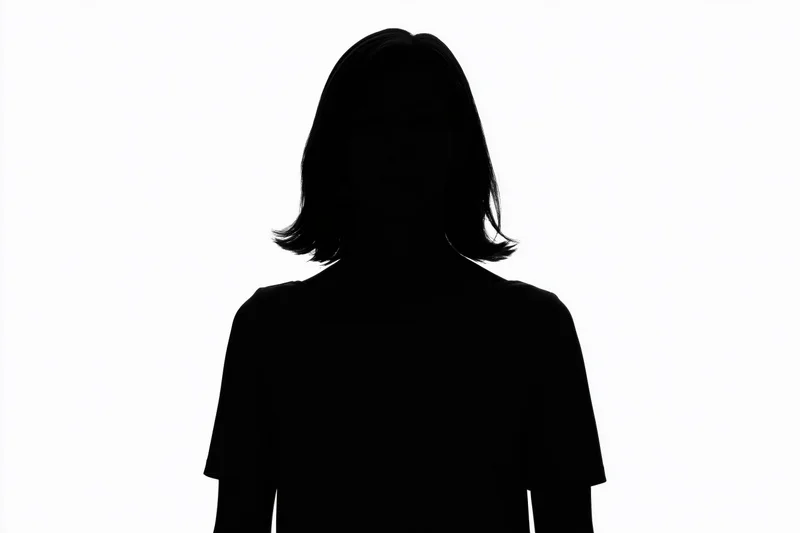Silhouette of a woman standing still facing forward against white background