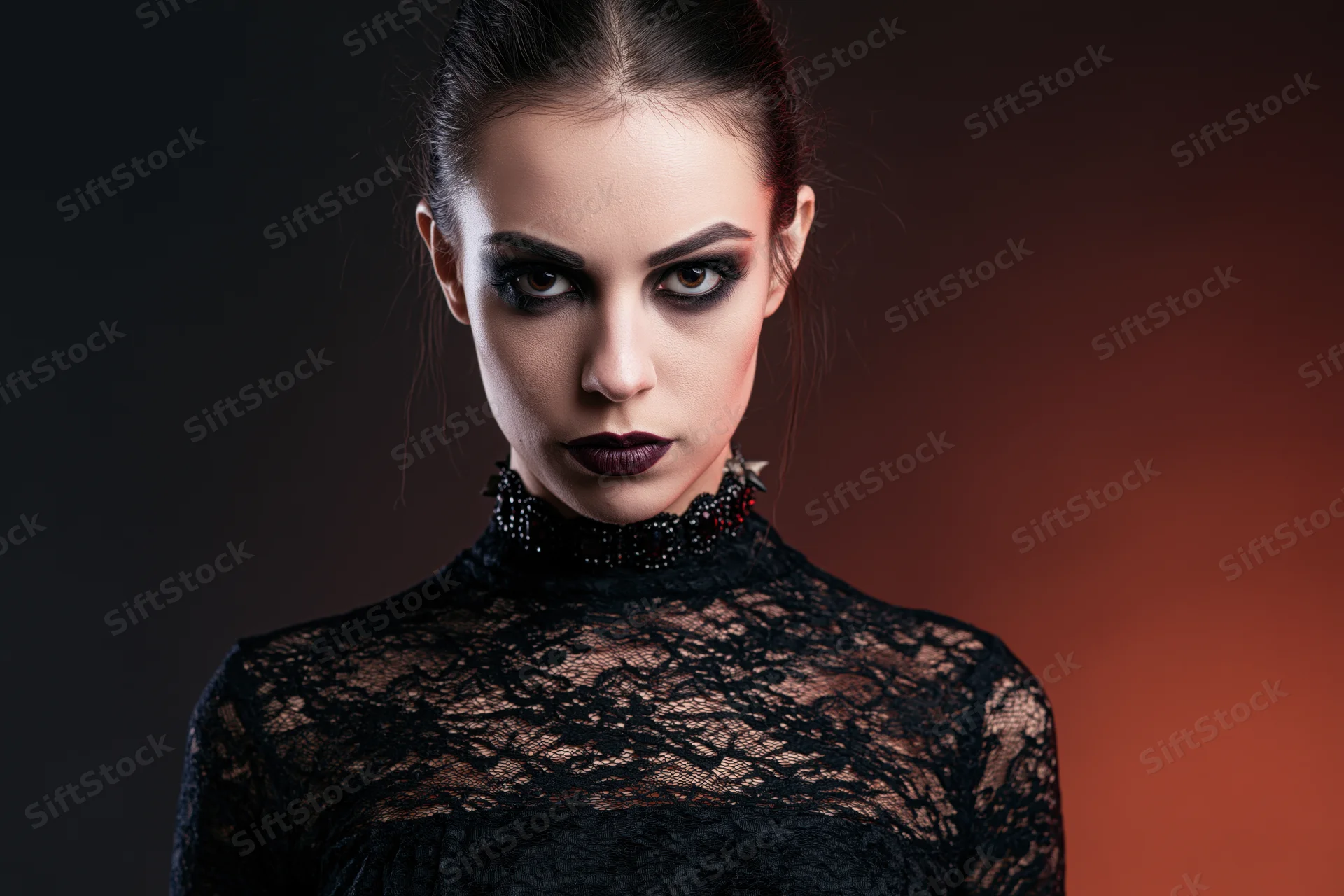 Woman in gothic vampire costume with intense stare, wearing black lace top and dark makeup, in studio lighting with gradient background