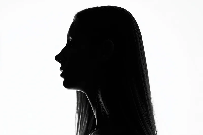 Silhouette of a woman in profile against a white background