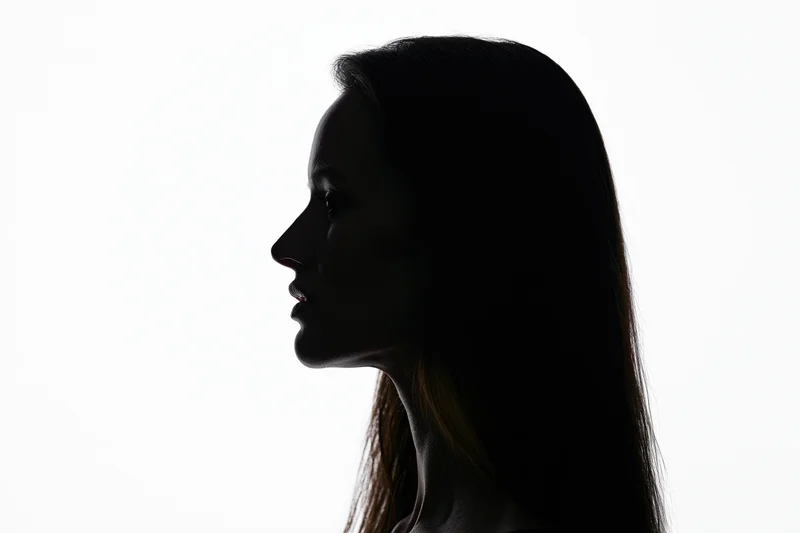 Silhouette of a woman's profile against a white background
